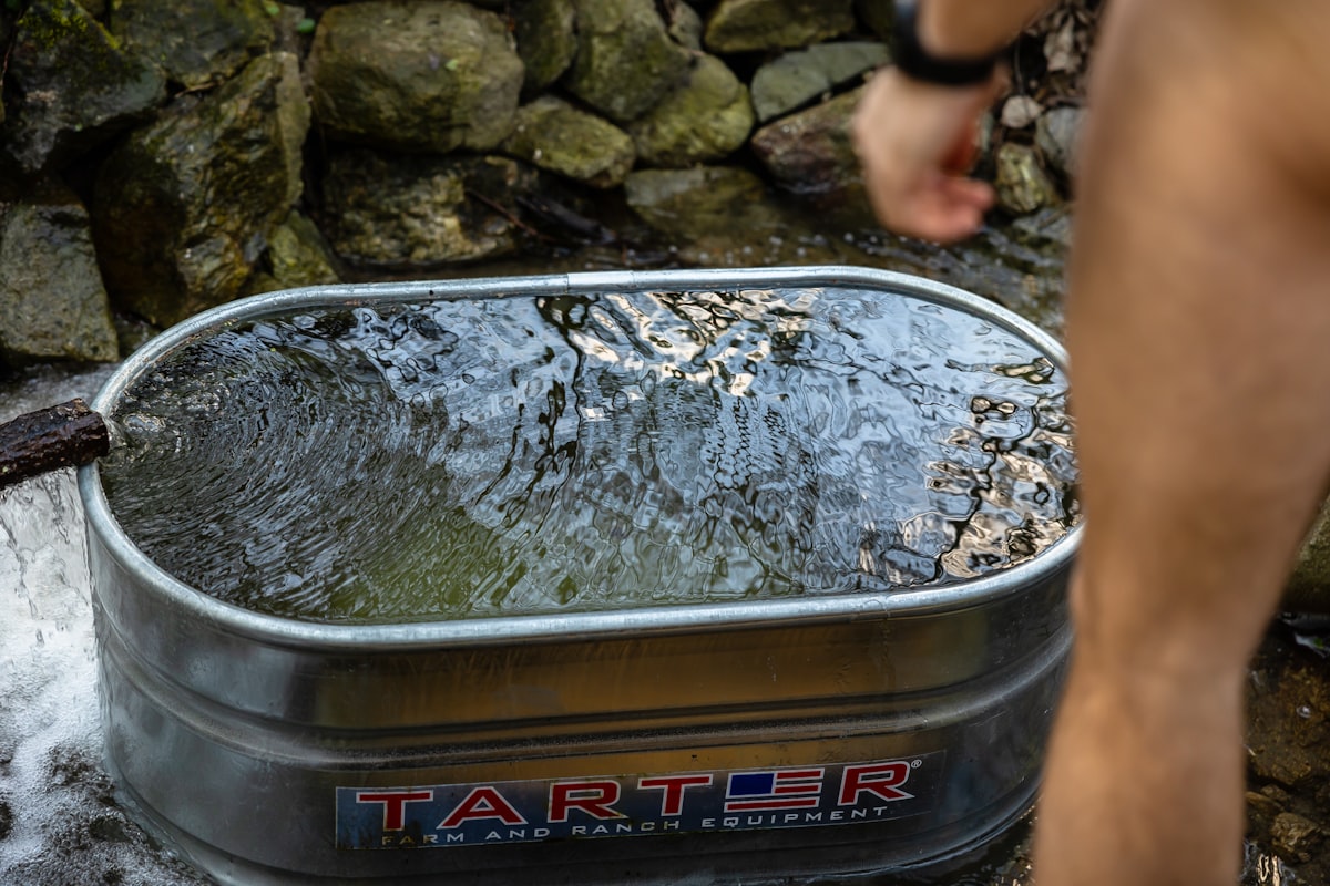 Person in cold plunge tub experiencing cold water immersion benefits